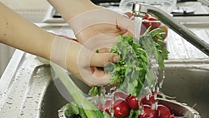 Woman washin vegetables