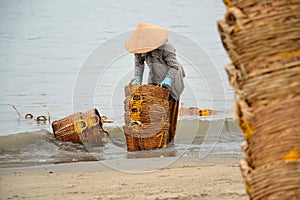 Woman washing baskets in Vietnam