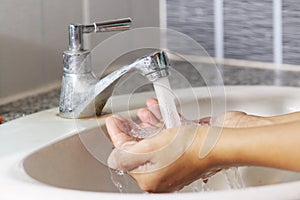 Woman washing, cleaning hand by water from trap