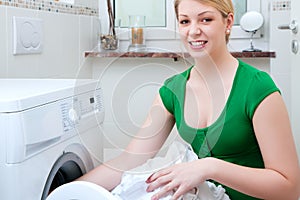Woman washing clothes with machine