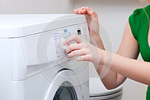 Woman washing clothes with machine