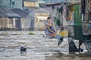 Woman washing clothes in Mekong river