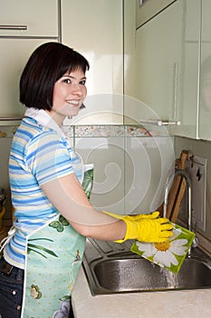 Woman washing dishes in kitchen