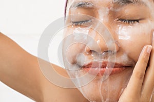 A woman is washing face