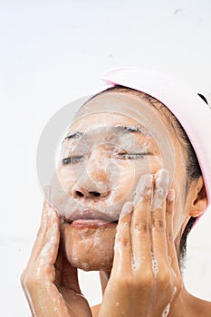 A woman is washing face.