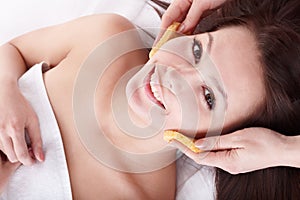 Woman washing face by sponge.