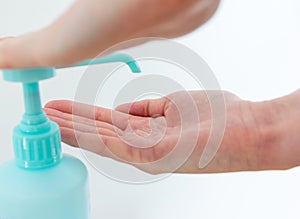 Woman washing hands with hand sanitizer alcohol antibacterial to prevent germs, bacteria and avoid coronavirus