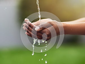 Woman, washing and hands in outdoor for hygiene with water drops for clean, healthy and wellness environment. Skincare