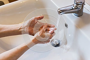 Woman washing hands with soap