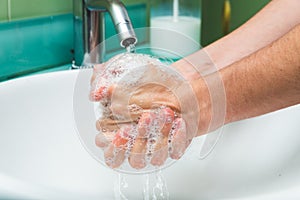 Woman washing hands under the water tap. Hygiene concept