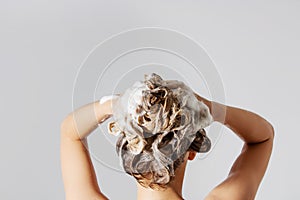 Woman washing her blond hair