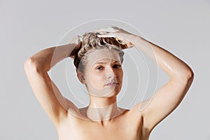 Woman washing her blond hair