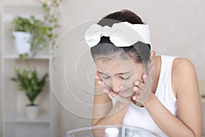 Woman washing her face