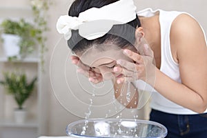 Woman washing her face