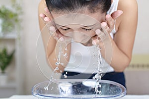 Woman washing her face