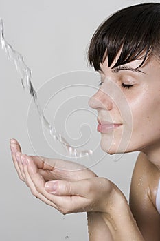 Woman washing her face