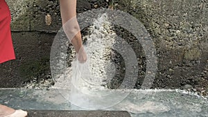 Woman washing her face and drinking mineral water from cold spring. Hydrogen sulphate-calcium gypsum waters transparent