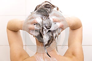 Woman washing her hair in shower