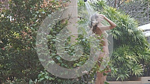 woman washing her hair under shower