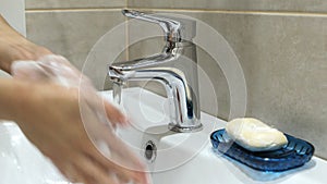 Woman washing her hands with soup to protect coronavirus pandemic