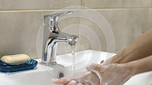 Woman washing her hands with soup to protect coronavirus pandemic