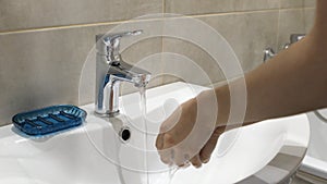 Woman washing her hands with soup to protect coronavirus pandemic