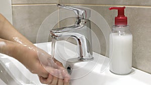 Woman washing her hands to protect coronavirus pandemic