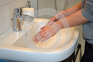 Woman washing her hands under running water