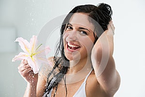 Woman washing herself with happy smile, lily flower