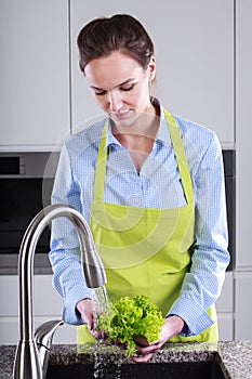 Woman washing lettuce