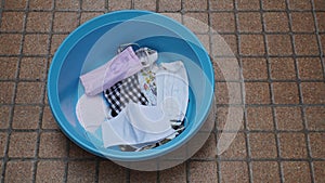 Woman washing mask in basin