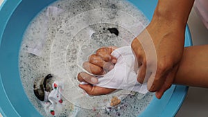 Woman washing mask in basin