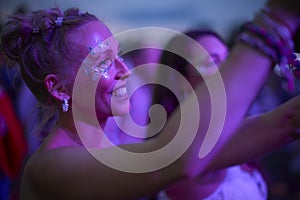 Woman Watching Band Dancing At Outdoor Summer Music Festival Holding Drinks At Night