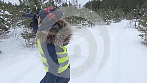 Woman watching through binoculars wild birds in winter