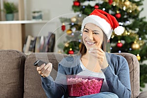 Woman watching christmas tv porgram at home