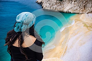 The woman watching the coast of KaputaÅŸ. Amazing beach from Kaputas, Antalya, Turkey. Holiday, tourism and travel background.