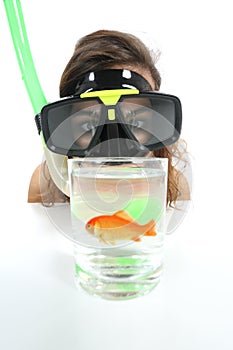 Woman watching a fish with goggles with holiday desire of diving