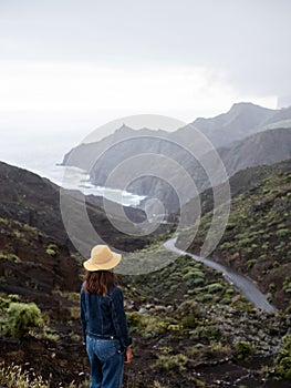 Woman watching the mountains landscape in La Gomera island photo