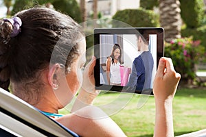 Woman watching movie on digital tablet