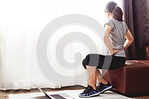 Woman watching online tutorials on laptop