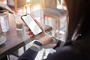 Woman watching smart phone and smart bracelet. hone with blank screen for mockup photo