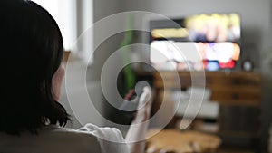 Woman watching smart TV at home