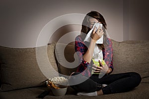 Woman watching a soap opera and crying