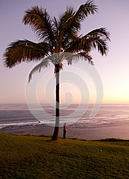 Woman watching sunrise in Kauai