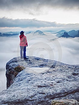 Woman watching sunrise over Himalayas, misty mountains photo