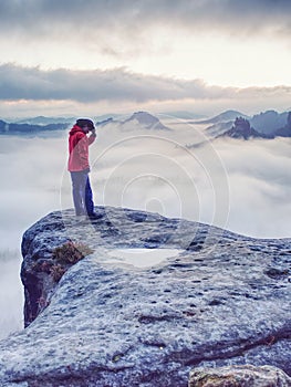 Woman watching sunrise over Himalayas, misty mountains photo
