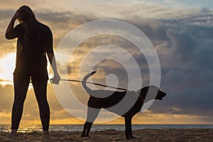 Woman watching sunset with dog