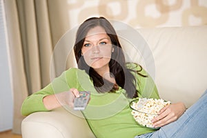 Woman watching television with popcorn