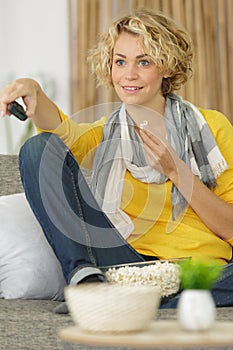 woman watching tv alone zapping channel