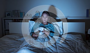 Woman watching tv in bed